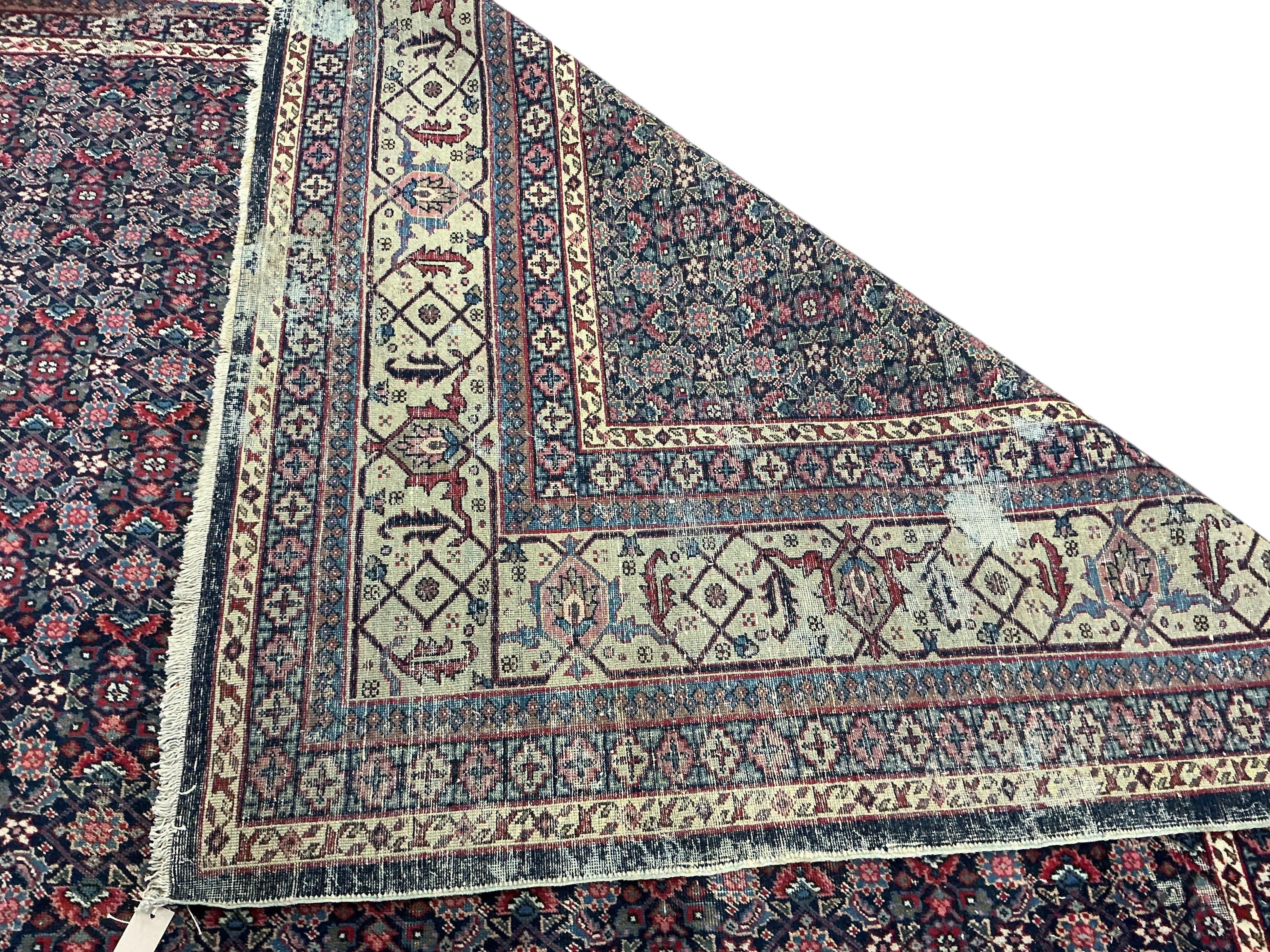 An early 20th century Tabriz blue ground floral carpet, moth damage, 440 x 340cm